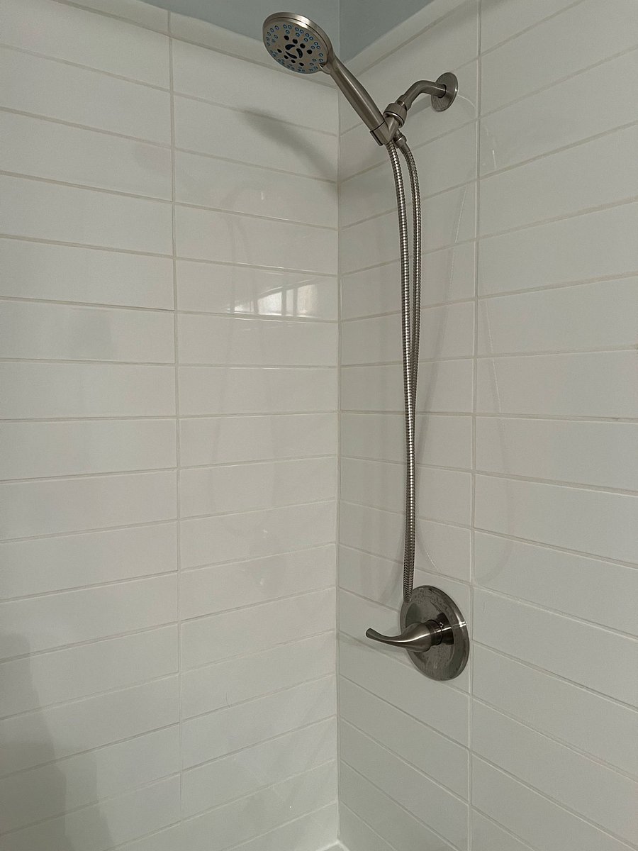 Guest Bathroom: newly remodeled shower/tub combo, wall mounted in-shower storage baskets, shower wand with multiple settings.