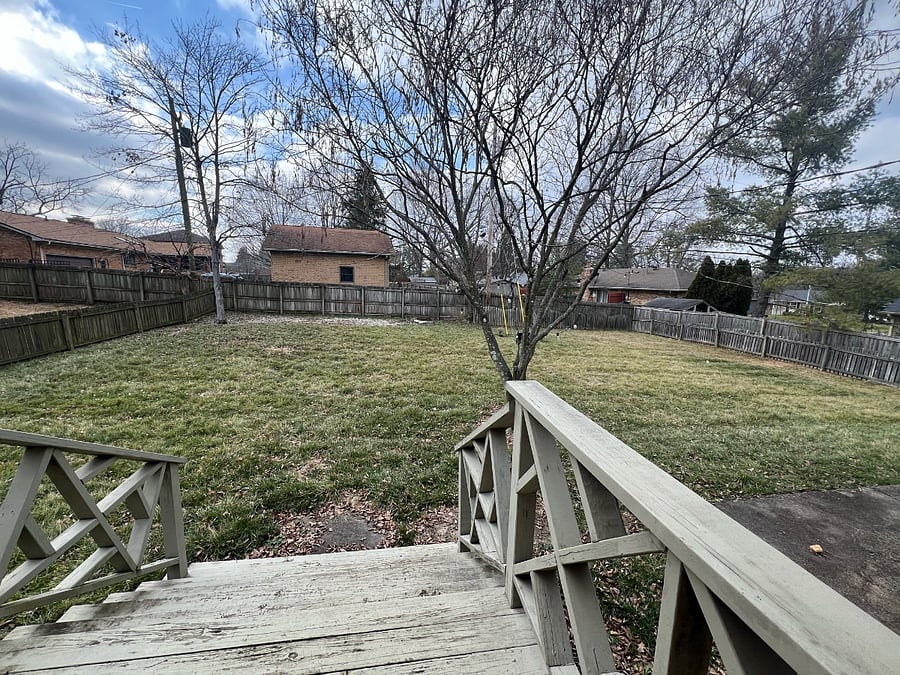 Privacy fenced large backyard. - has deck, patio furniture (not shown) and solar lights in trees (can be turned on/off).