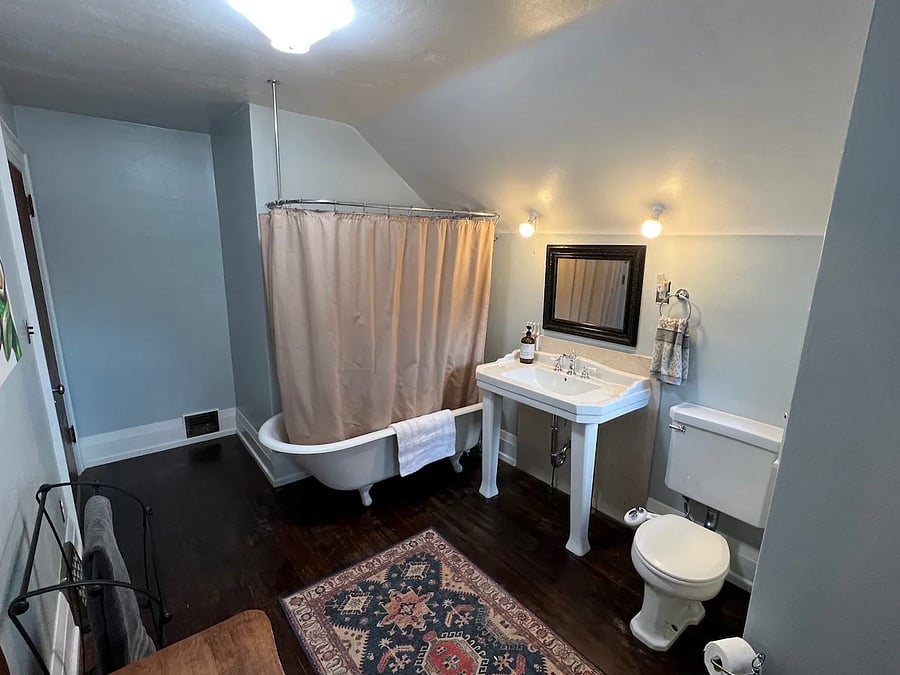 Large, upstairs bathroom with elegant clawfoot tub.