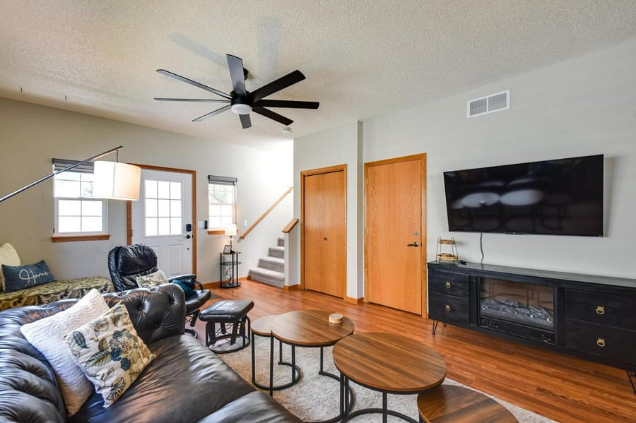 Living Room, Front Door, Coat Closet, Lower Level Access Door next to TV
