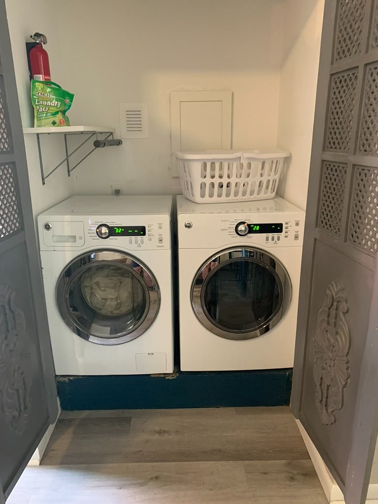 Washer and dryer behind decorative doors