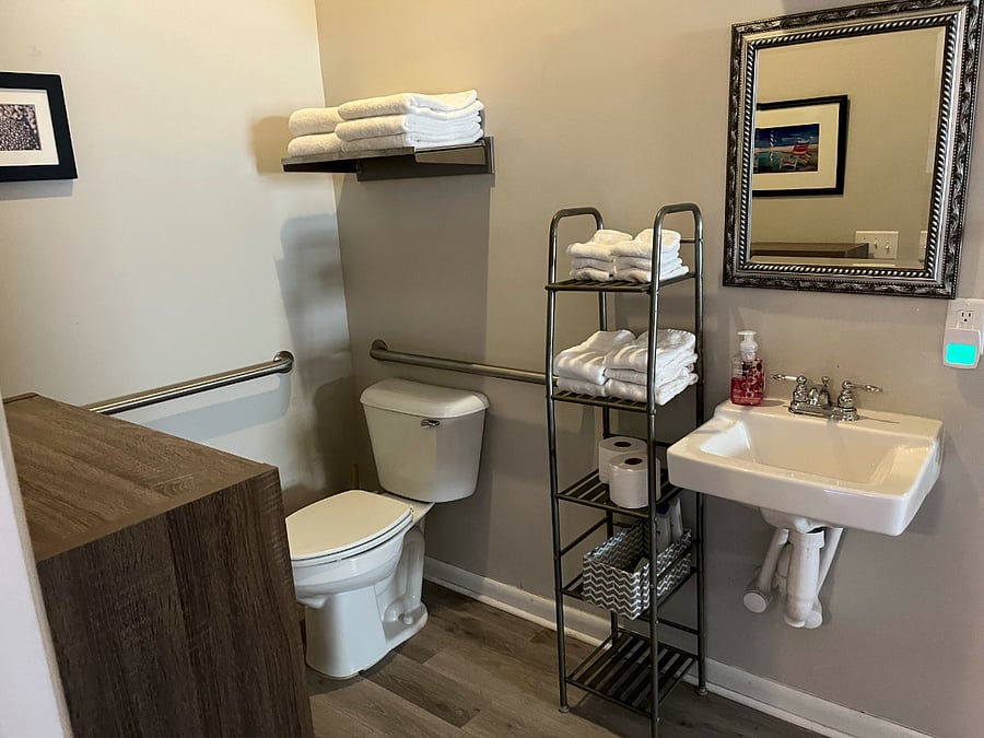 Bathroom with linen storage and handicapp accessible.