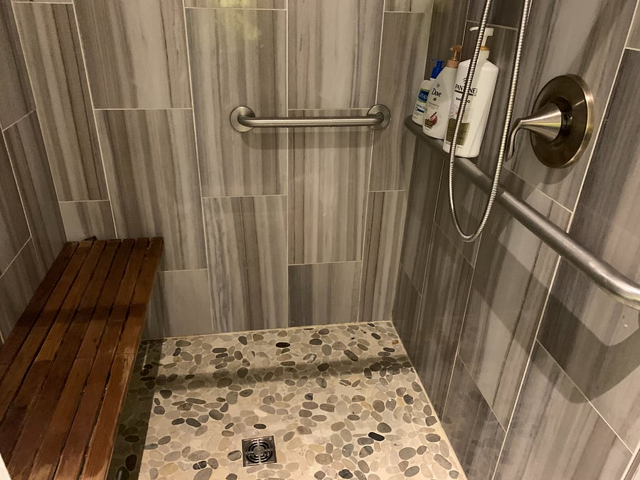 Walk in tiled shower with bench and 2 shower heads