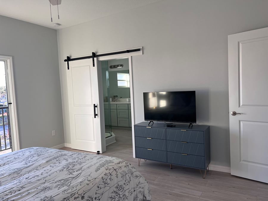 Master bedroom with bar door to the bathroom