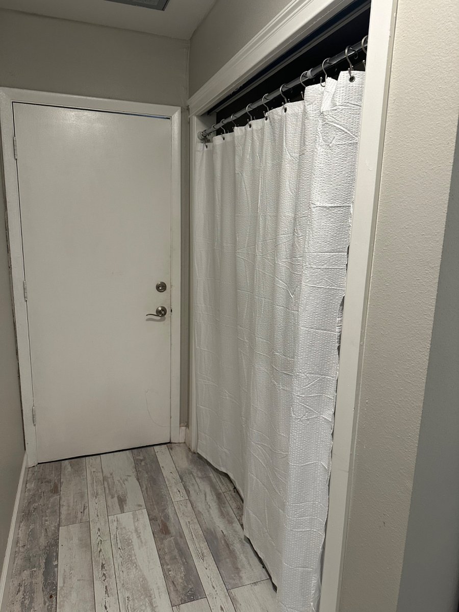 Entry to garage - washer and dryer (brand new) behind curtain