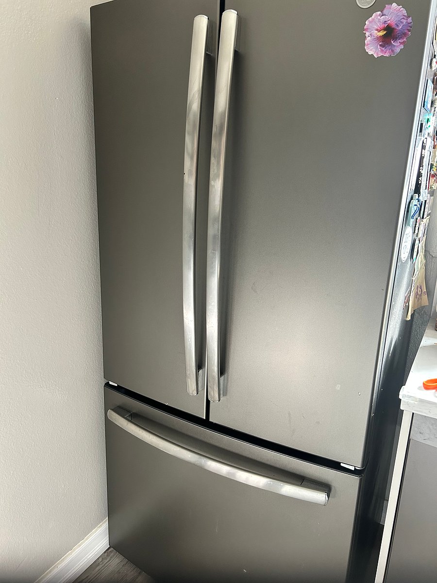 Full size fridge in kitchen, shared space
