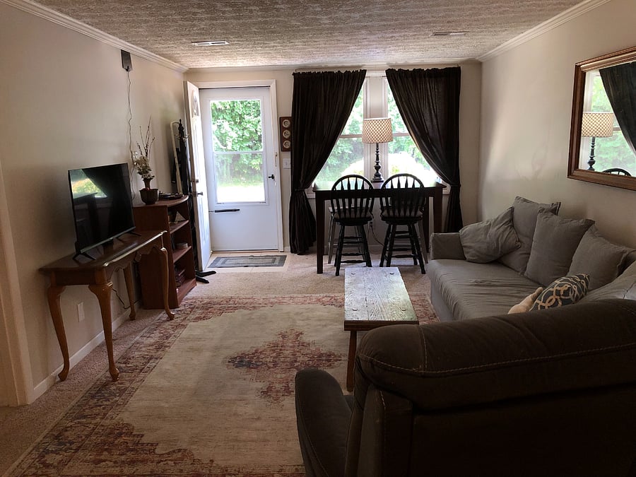 Main room with Smart TV, roll top desk and pull out couch