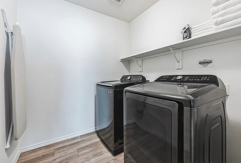 Upstairs laundry room with a brand new Samsung washer and dryer