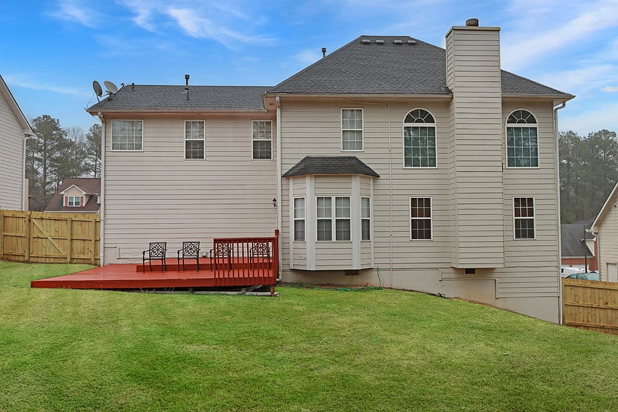 Spacious, fenced backyard with a deck and seatingperfect for outdoor relaxation and privacy.