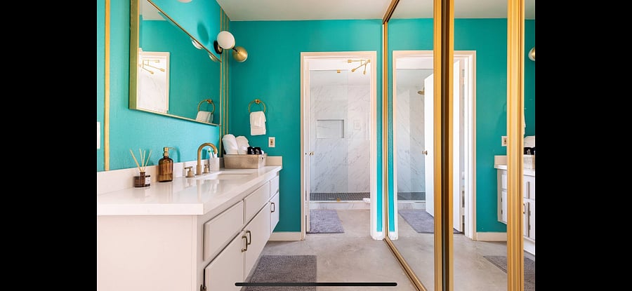Three large sliding mirrored door closets.