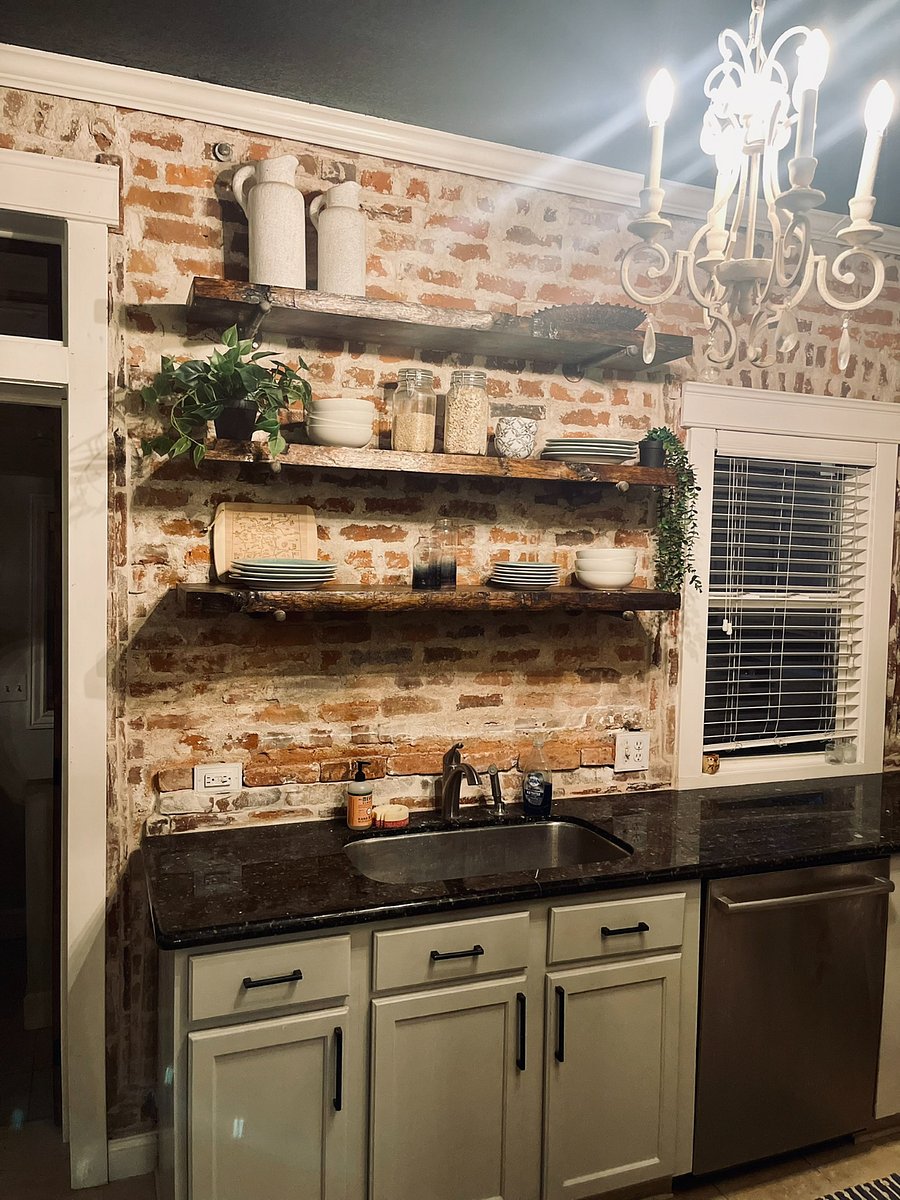Kitchen: Beautiful exposed brick and live edge wood shelves.