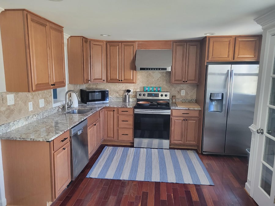 Modern kitchen with granite counter and stainless steel appliances. All amenities included in kitchen such as refrigerator,dishwasher, garbare disposal, stove, microwave. Also toaster, air fryer and all other kitchen tools needed.