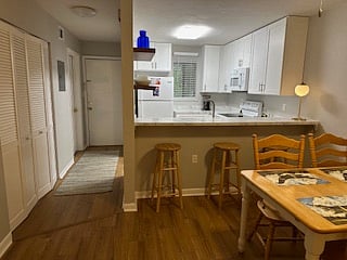 view of kitchen and hallway to front door