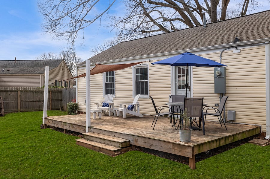 Larged fenced backyard with shade for relaxing and dining on the porch, bistro lights, hammock and firepit.