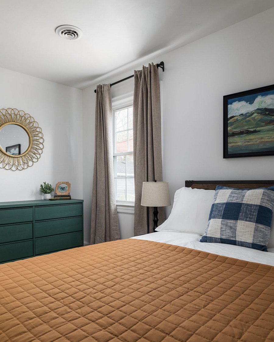 Primary bedroom with comfortable queen bed, dresser, and closet