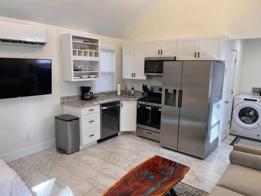 Brand new stainless steel appliances, full size refrigerator, gas stove, quiet dishwasher, microwave, TV, washer & dryer and granite counter tops.