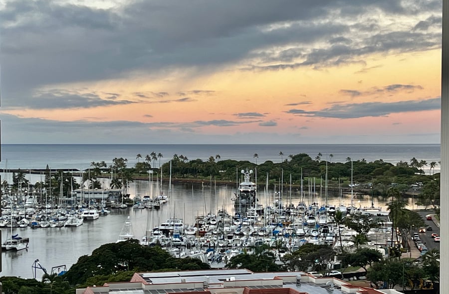 Every room has a view of the harbor, beach, and sunset