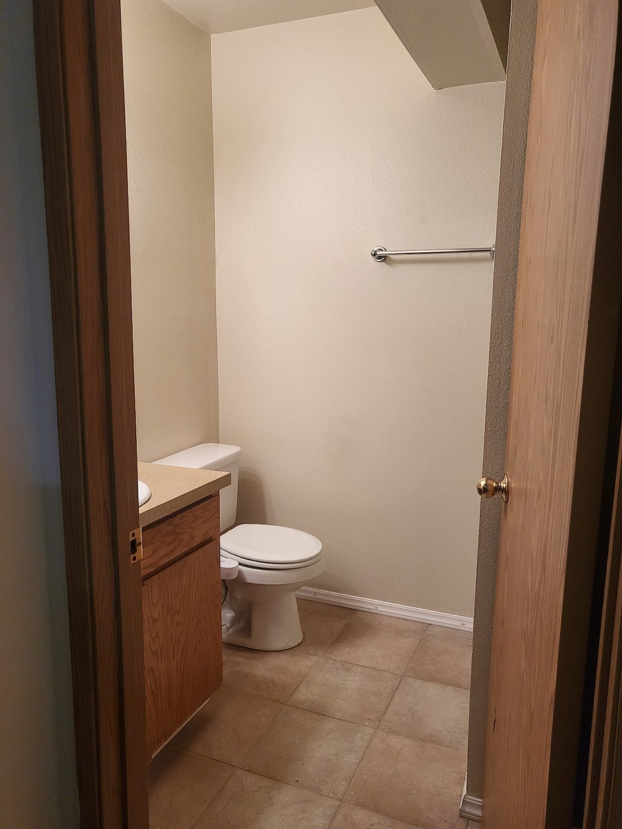 Main level bathroom with shower, sink, and toilet with bidet.