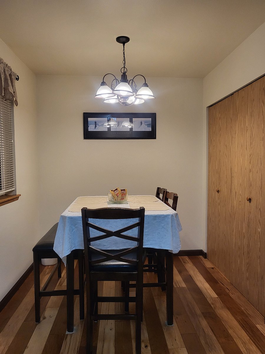 Dining area with bar height table, chairs, and bench.