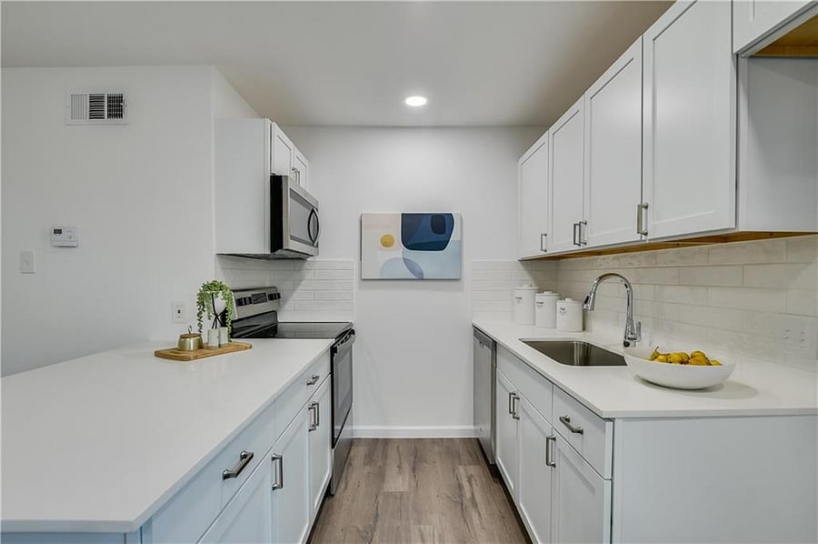 Full kitchen with full size fridge, microwave, and fully stocked pots, pans, baking pans, etc.