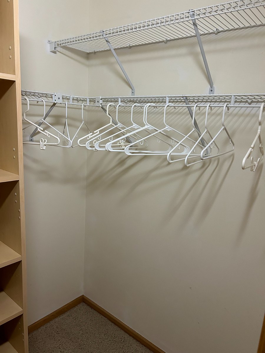 Plenty of hanger space for clothes in walk-in closet