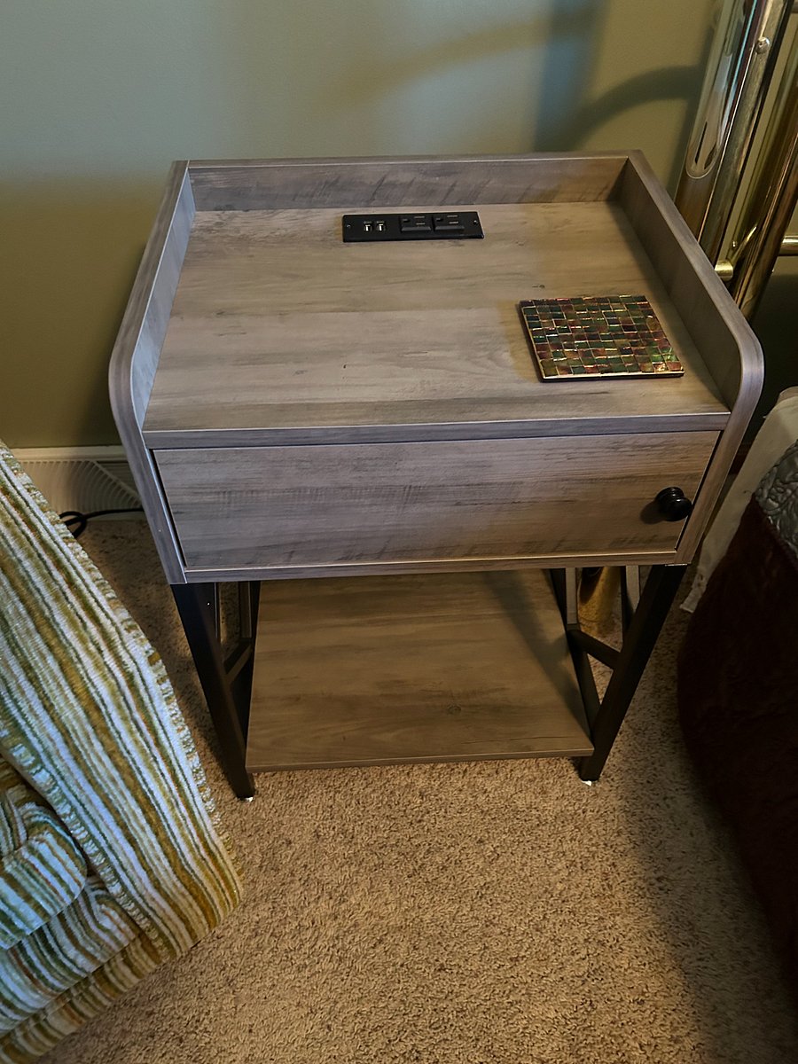 Close up of bedside nightstand with built in USB ports and electrical outlets to easily charge your phone / tablet / computer.