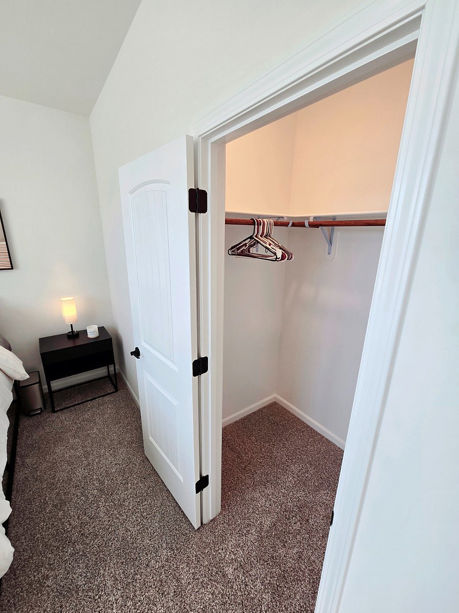 Private bedroom with full-sized bed, night lamp with USB charging ports, large night stand with storage, walk-in closet, ottoman, 6-drawer dresser, and 40-inch screen TV with firestick.