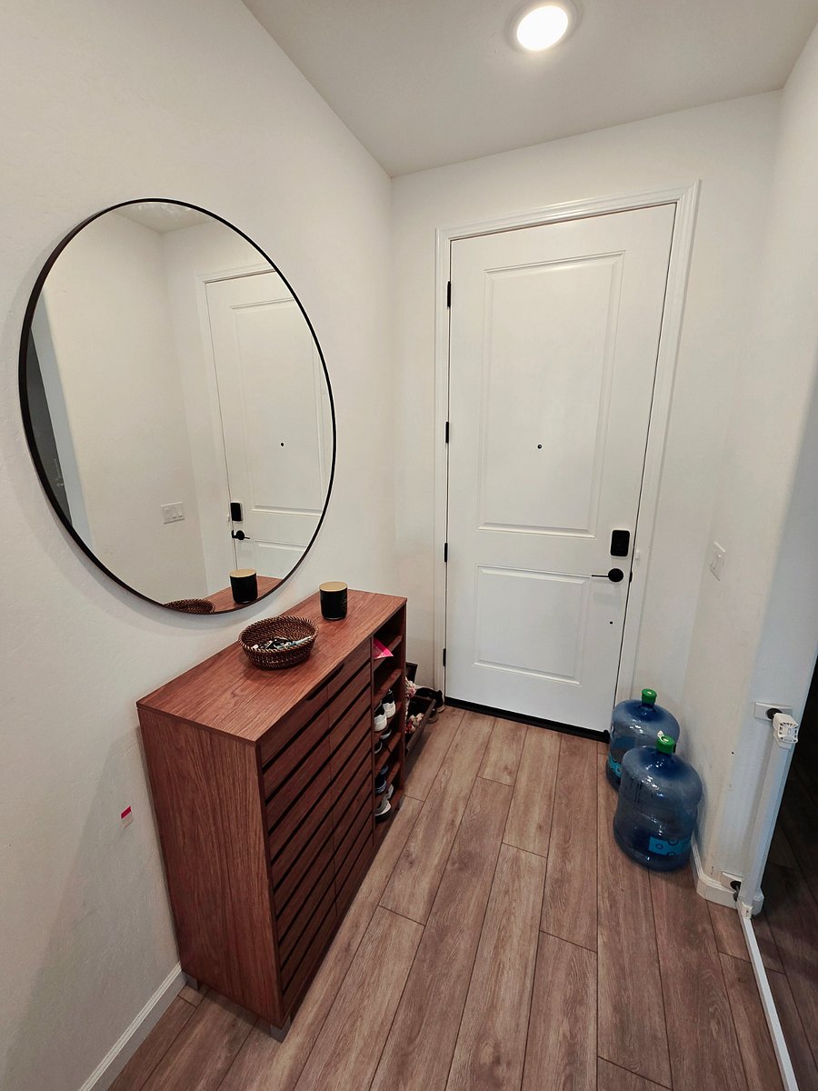 Shared front entrance with mirror and ample shoe storage.