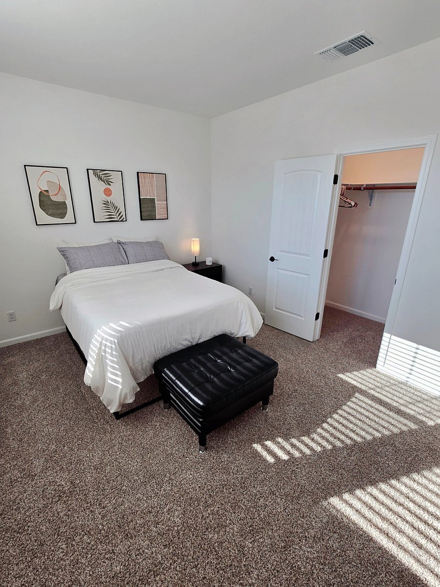 Private bedroom with full-sized bed, night lamp with USB charging ports, large night stand with storage, walk-in closet, ottoman, 6-drawer dresser, and 40-inch screen TV with firestick.