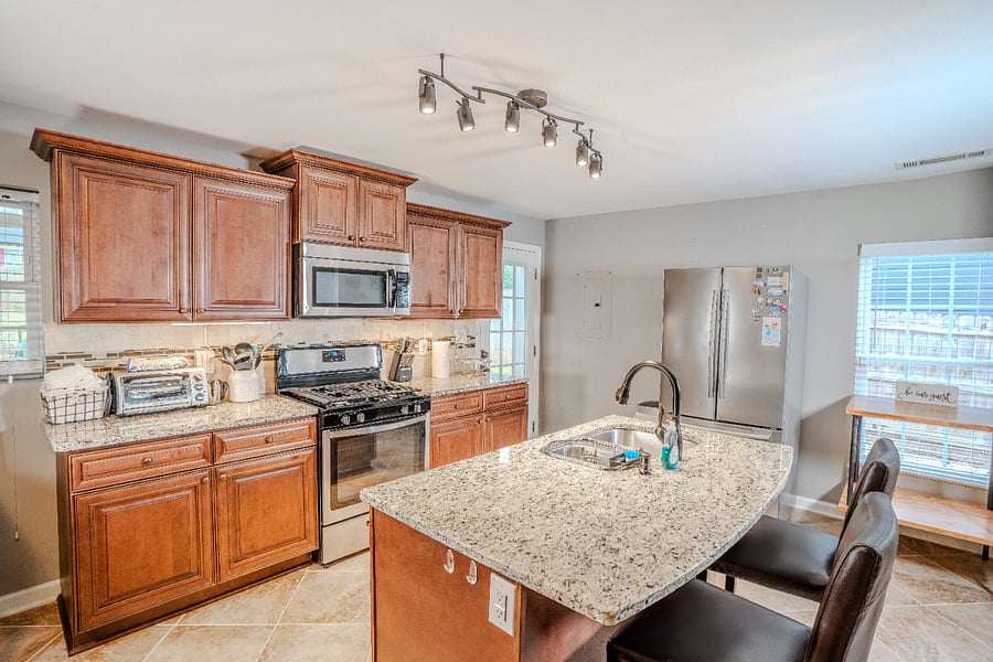 Kitchen with gas stove and garbage disposal.