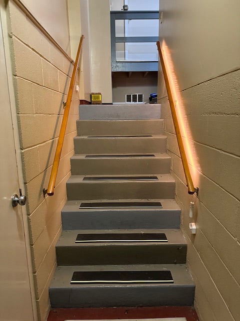 Stairs up to garage with anti-slip treads, glow in dark strips and motion sensing lights.