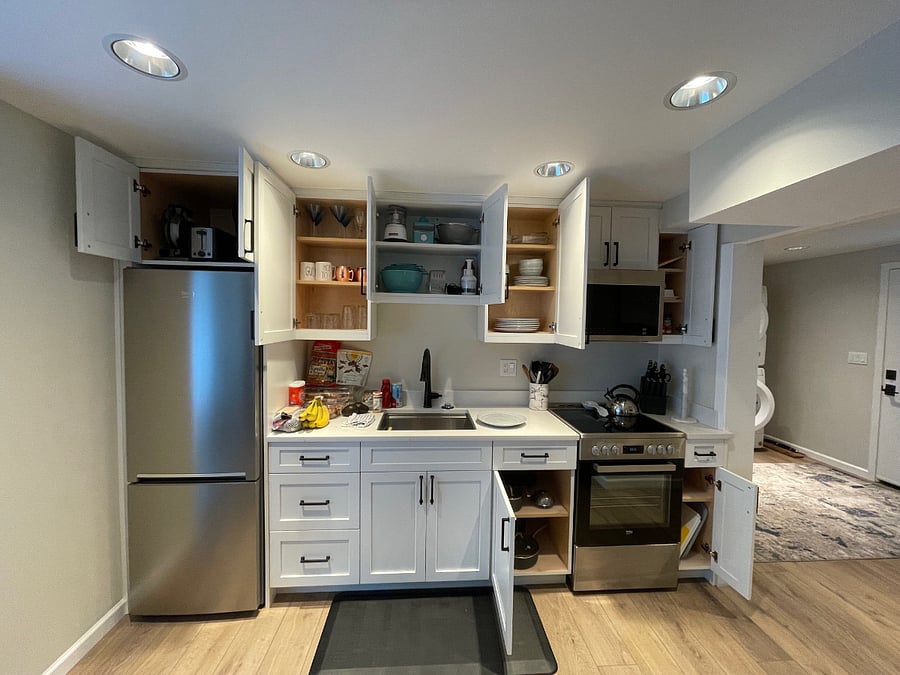 Open cabinets to show all the dishes, cookware & appliances (coffee maker, waffle iron, juicer, toaster, blender, popcorn maker, chopper)