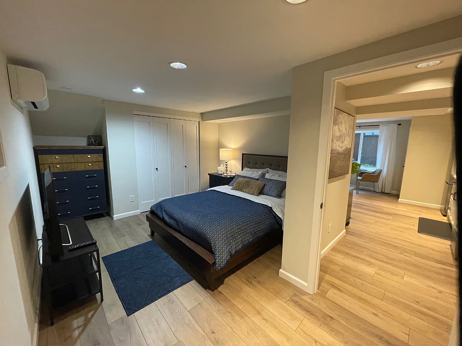 Bedroom with queen bed with extra blankets. Phone charger & sound machine. Closet with iron, ironing board & steamer. Full dresser with jewelry box. TV and mini-split with heat and air conditioning. Black out curtains.