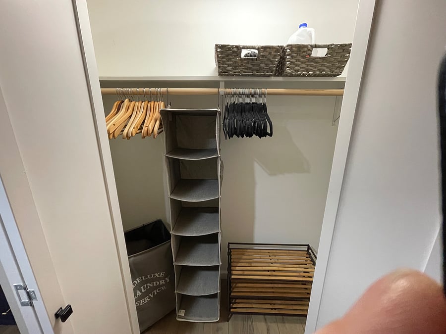 Closet with organizational items and storage for suitcases