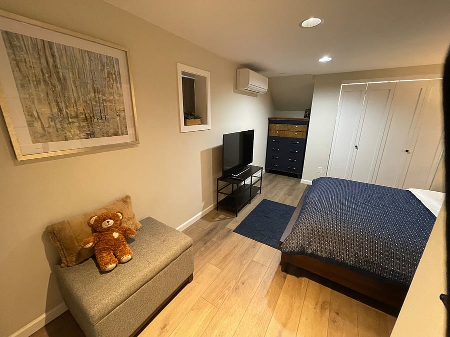 Bedroom with gray storage ottoman