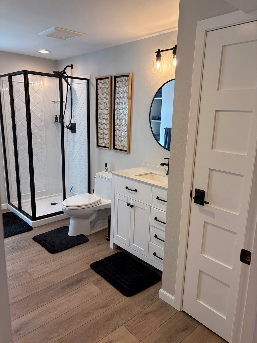 Extra wide door entry to bathroom, towels, rugs, starter toiletries, cleaning supplies, hair dryer, sewing kit, hand-held shower, scale, utility closet, obscured window.