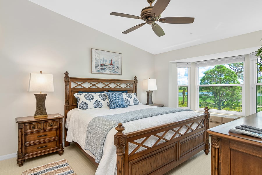 Master King Bedroom with new mattress, luxury linens, ensuite bathroom, 2 custom walk-in closets, dresser, 55-inch TV and lanai access.