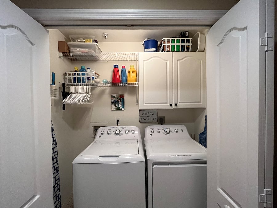 Full-sized washer and dryer. Starter supply of detergent and cabinet with handy tools.
