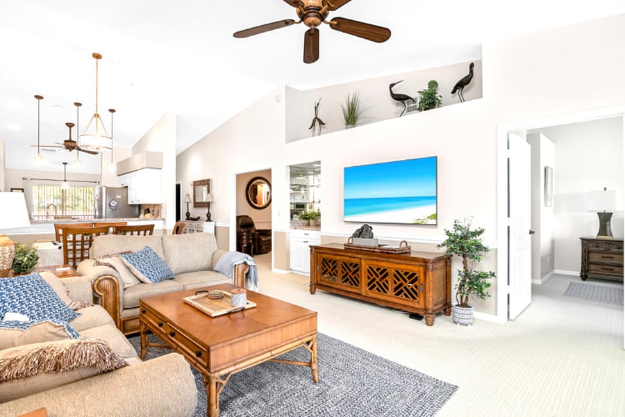 Living room with new 65-inch wall mounted smart TV, bar and plenty of light.