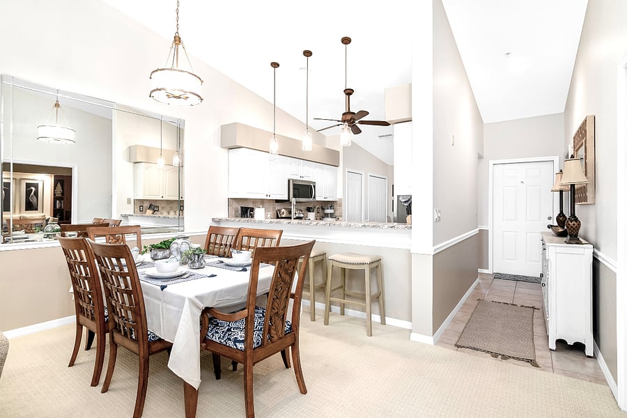 Formal dining area and barstools at the kitchen counter.