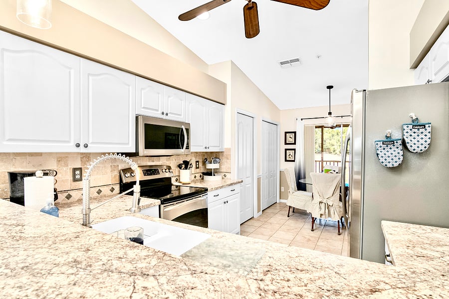 Stainless appliances and chef-style kitchen faucet.