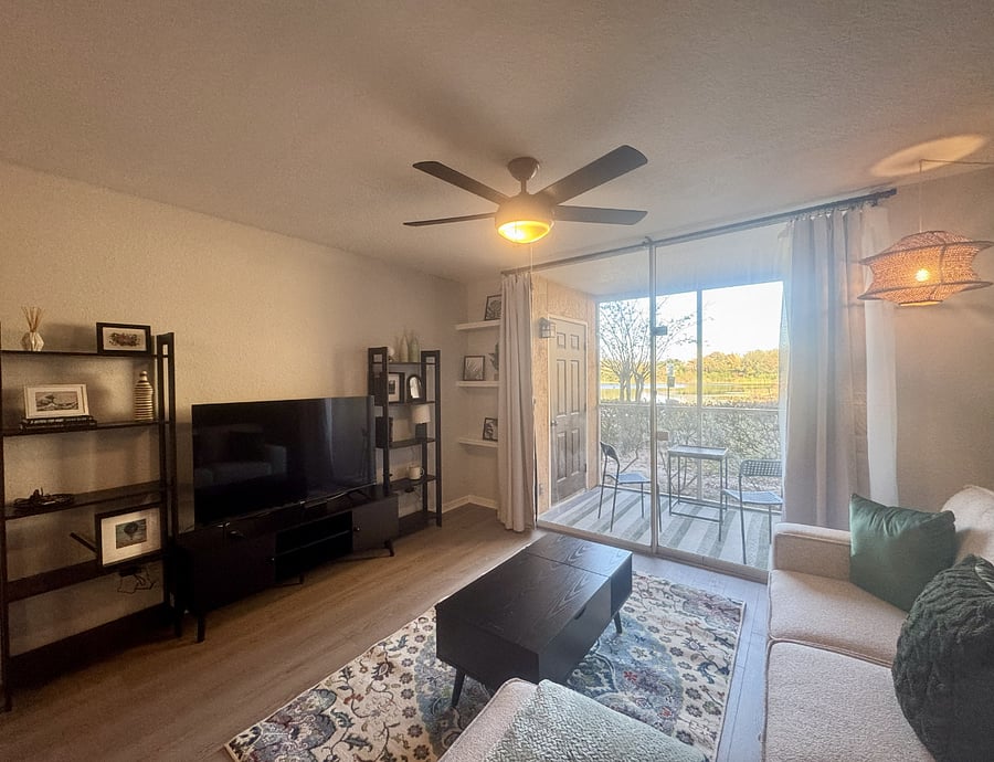 The living rooms features a 55" smart TV. The private screened patio looks out to the lake.