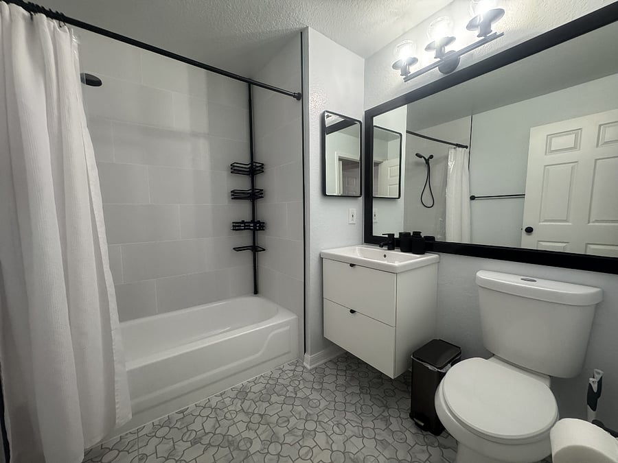 The bathroom features a full-sized bathtub.