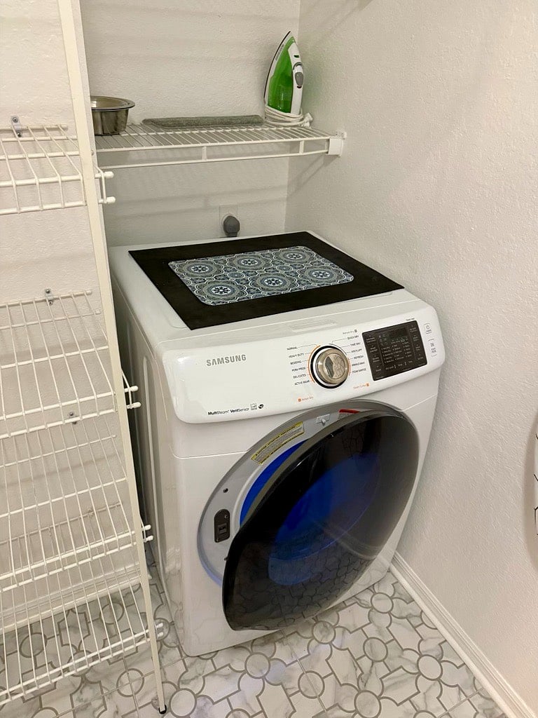 Brand new full-sized Samsung dryer within the apartment (through the doors to the back of the kitchen).