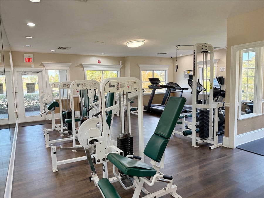 Gym with cardio machines, free weights, and cable machines
