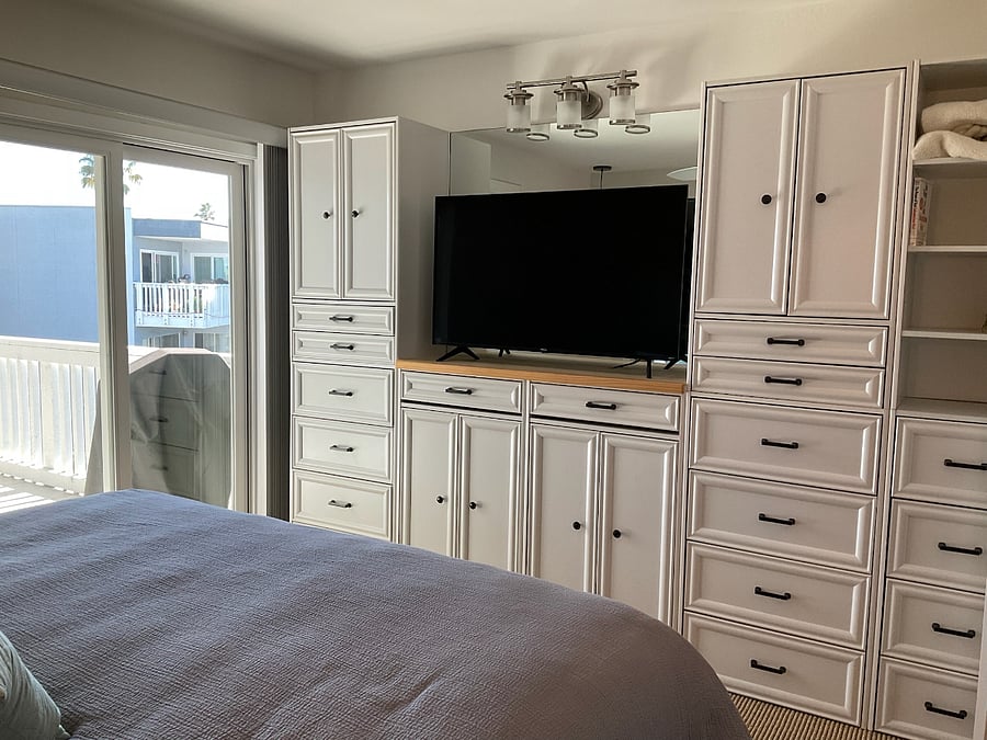 Bedroom with 50" Smart TV, slider door leading to balcony