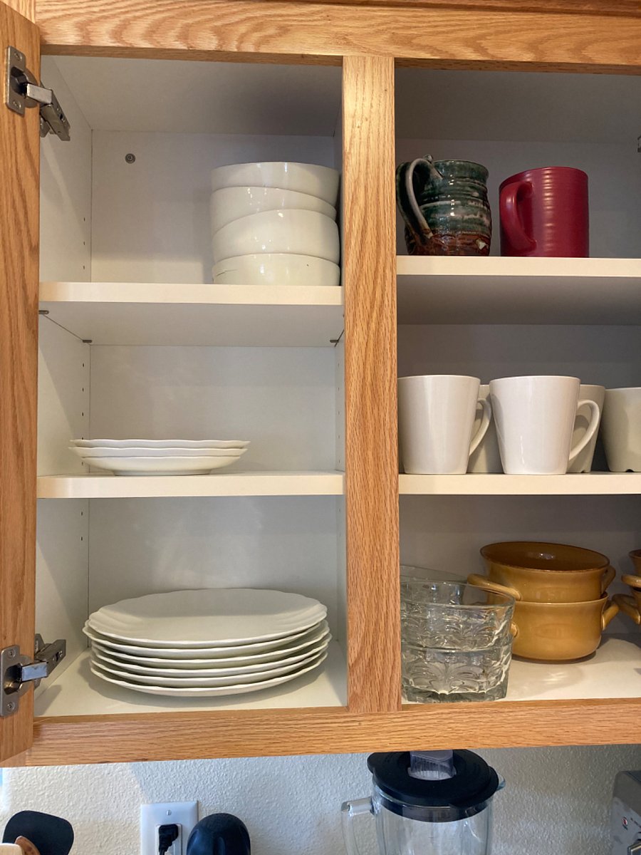 Fully stocked with plates, bowls, glasses, and mugs