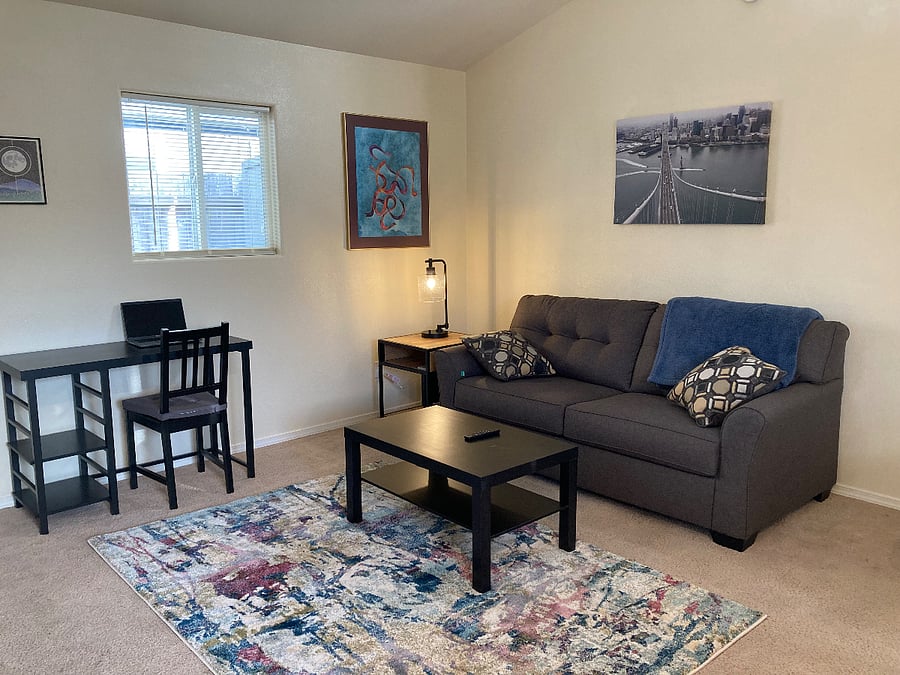 Homey living room with coffee table, side table, and fun artwork