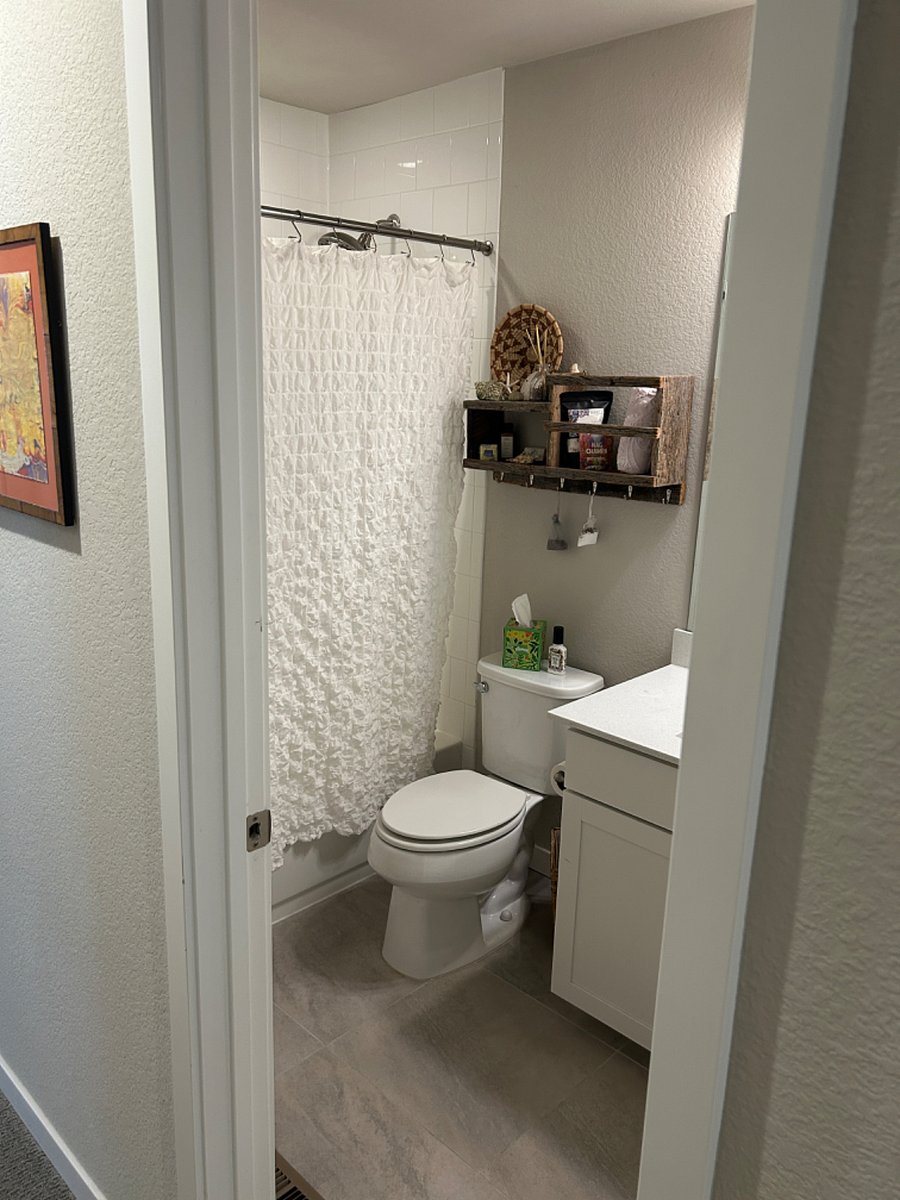 Private bath just across the hallway from queen bedroom.