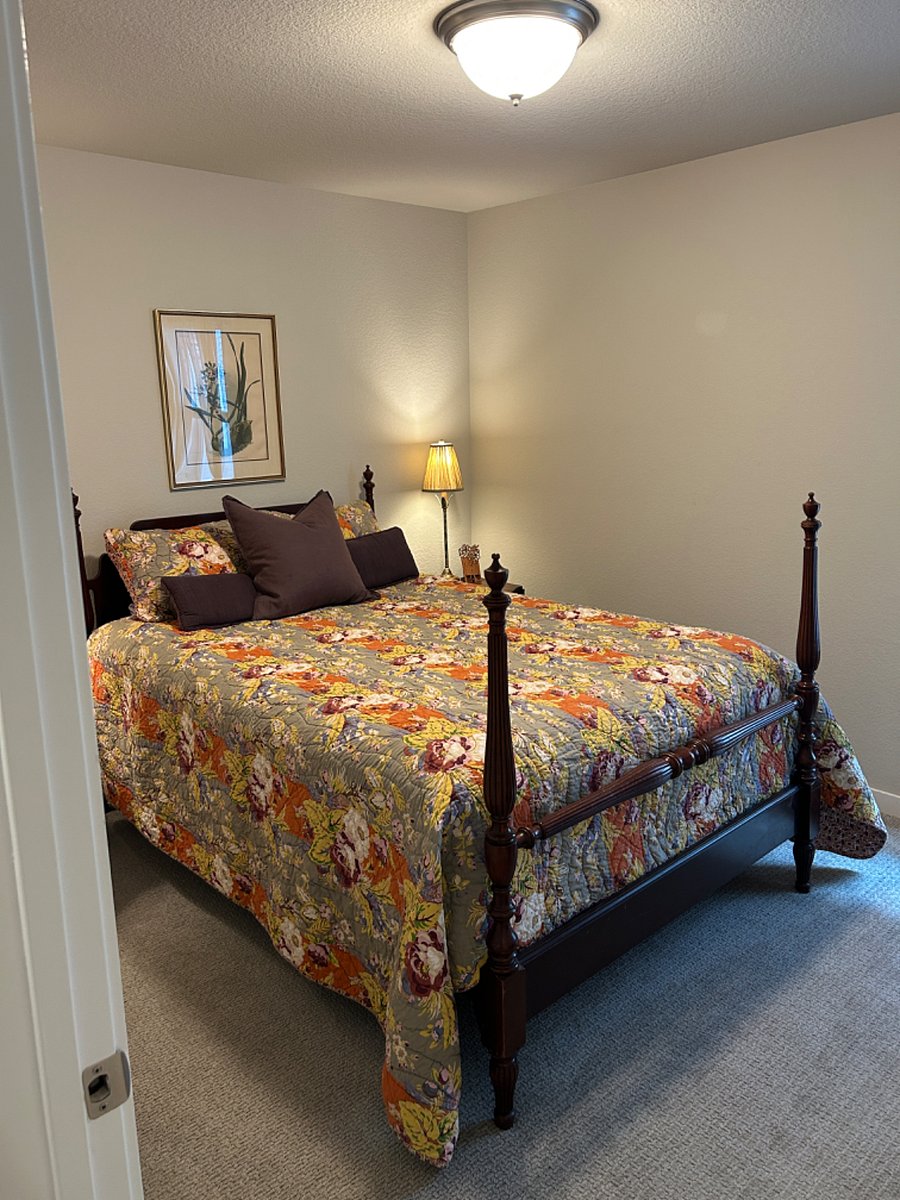 Furnished queen bedroom with deluxe mattress and antique mahogany furniture and spacious closet.